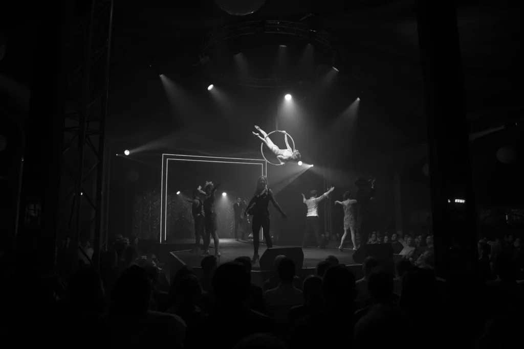 The electro swing project perform a circus show live on stage at the underbelly festival in a black and white photo